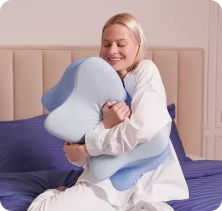 Happy customer hugging her Derila Ergo Pillow