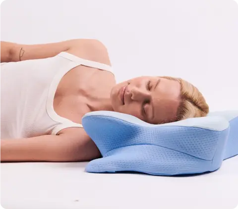 Sleeper with arms resting in Derila Ergo Pillow arm channels
